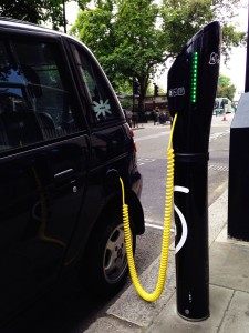 A photograph of a car being charged at an electric charing point in London.